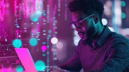 A focused man with glasses analyzes data on a laptop, bathed in neon light. The image reflects technology and business.