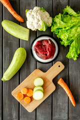 Cooking natural pet food with meat and vegetables, top view