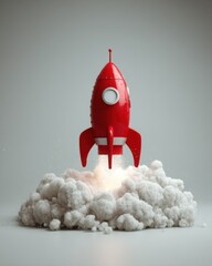 Red Toy Rocket Launching with Smoke on Gray Background Studio Shot for Startup Concept and Space Exploration