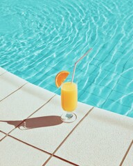 Refreshing orange juice drink with straw and slice at pool edge summer vacation lifestyle poolside view