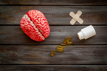 Human brain model with medical pills and patches, top view. Mental health concept.