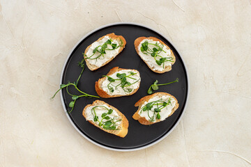Healthy snack - sandwiches with microgreens on plate, top view