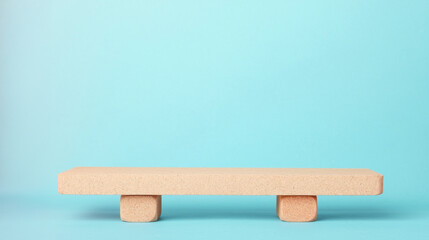 A minimalistic wooden stage against a blue background, perfect for display purposes.