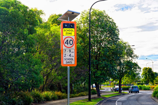 School zone warning sign with 40 km signal lights on the side of the road