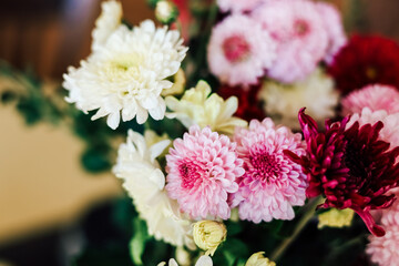 Colorful bouquet of flowers displayed in a warm interior setting during daylight hours