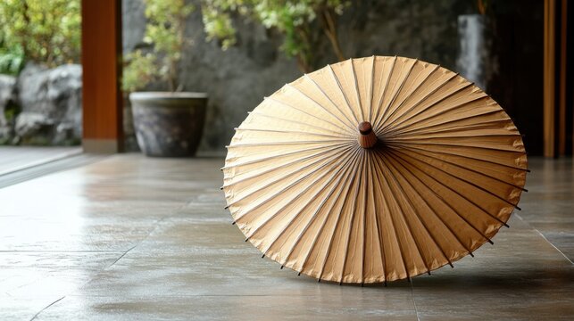 A traditional Chinese umbrella made of oiled paper, displayed closed on a neutral floor 
