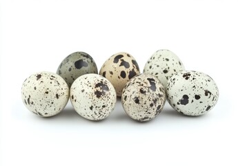 Obraz premium Assorted Quail Eggs with Unique Brown Speckles on White Background