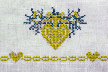 Cross stitch. Cross-stitch heart. Needle and thread. Cross stitch and simple embroidery.