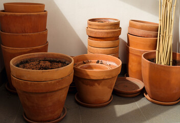 Stacks of plant pots, used old empty terracotta flower pots