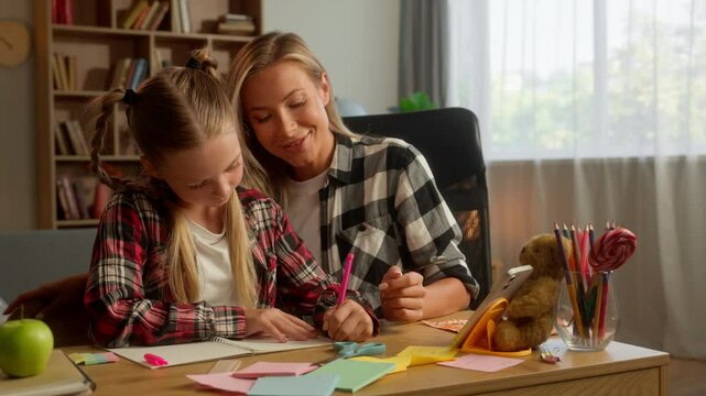 Carefree Caucasian family daughter learning mother helping educate at home girl student schoolgirl writing child drawing mom pointing woman speak lesson parent kid study together tutoring schoolwork