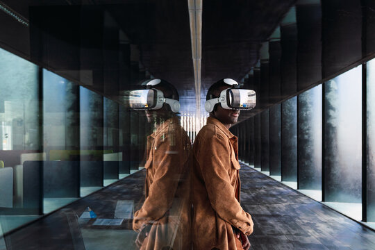 Professional wearing vr headset, working collaboratively in sleek corporate environment, exploring digital workspace transformation