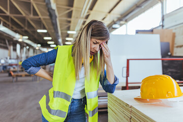 Female Construction Worker Experiencing Stress in an Industrial Worksite Setting