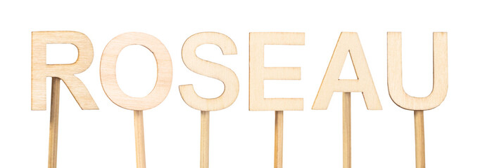 Roseau, capital of Dominica, written in light wooden letters on white background