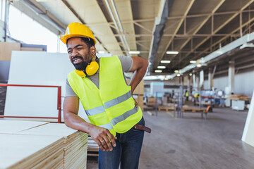 Worker in Factory Suffering From Back Pain Due to Workplace Injury