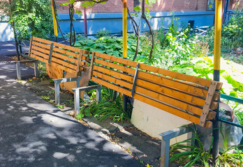 Wooden benches with seats raised and secured with a lock are a way to prevent nighttime gatherings...
