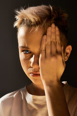 Young boy confidently expressing uniqueness and individuality under dramatic lighting