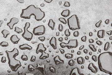 A wet surface with many small drops of water scattered across it