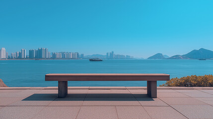 empty seaside promenade with concrete tiles, view of distant city skyline and mountains across the ocean, clear blue sky, warm morning sunlight, calm summer atmosphere