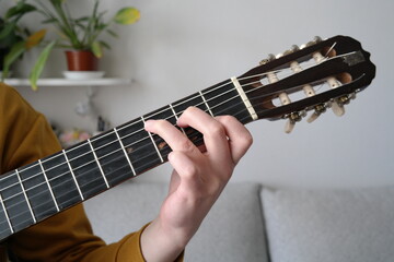 hand playing guitar chord closeup