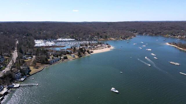Drone footage of Bird Island between Northport Bay and Centerport Harbor, showing coastal homes, marinas, and the shoreline of Long Island&rsquo;s North Shore on a peaceful sunny day.