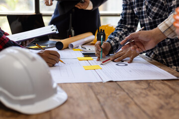 Team of architects and engineers working on construction project. Architect and engineer are using...