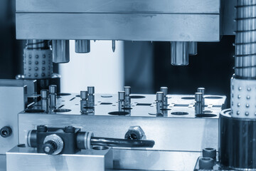 The metalworking process by progressive die in the light blue scene.