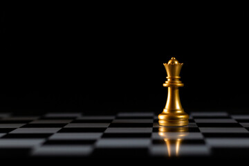 chess queen strategy leadership decision. golden chess queen stands out in the center board on a pitch black background, symbolizing leadership and strategy. golden chess queen is ideal for business. © Viriyastock88