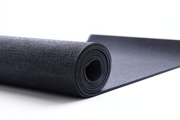 Close-up of a rolled-up dark gray yoga mat against a white background. Perfect for fitness, health, and wellness content.