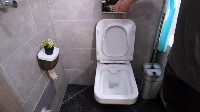 Man in toilet with urination problem, flushing toilet, man with prostate adenoma in toilet. Slow motion