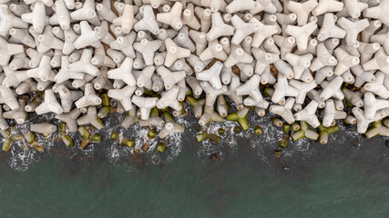 Aerial view of concrete tetrapod. Concrete tetrapods line.  Coastal protection. Wave breakers