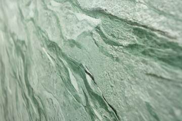 Softly textured green marble with gentle swirls and matte stone finish.