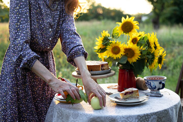 girl serving tea table in the garden