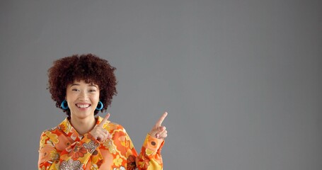 Woman, portrait and pointing up in studio for fashion announcement, notice or info with retro style...