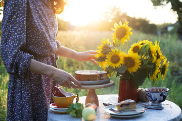 girl serving tea table in the garden