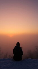 Silhouetted Figure Contemplating a Misty Sunset