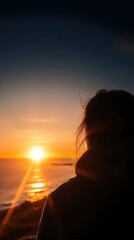 Silhouette of a Woman at Sunset: A Serene Coastal Scene
