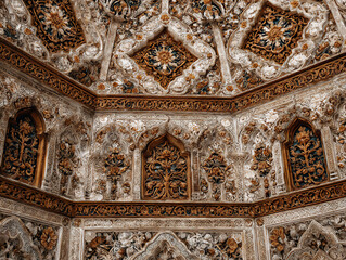 high-angle photograph of a repeating geometric islamic tile design on a palace floor with warm earth