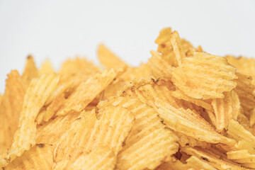 Close-up of irregularly shaped yellow chips, varying shades of gold, soft lighting, neutral background, realistic style, likely culinary or marketing context