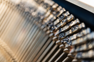 Close-up view of gleaming precision gears arranged in a linear fashion within an automated...