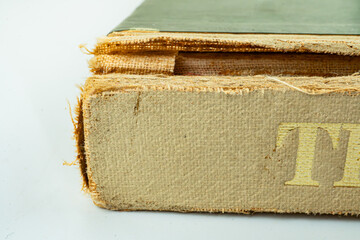 An old, worn book with a rough cover and pages filled with stories from the past Title suggests part of a series or larger work Well-read, possibly passed down generations or carried on adventures