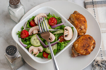 seasoned chicken thighs  with a garden salad