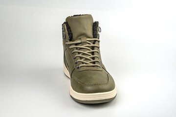 Image shows an olive green high-top boot with white laces on a gray background, suggesting durability and comfort