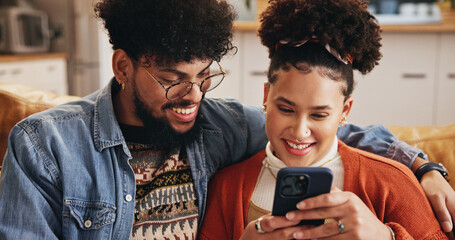 Mobile, happy couple and embrace in home to relax with social media post, video and financial news....