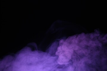 Beautiful smoke in purple light on dark background, space for text
