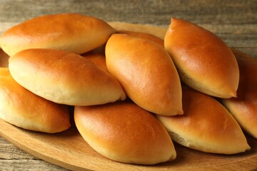 Tasty baked patties on wooden table, closeup