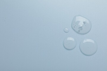 Collagen gel on light blue background, top view. Space for text