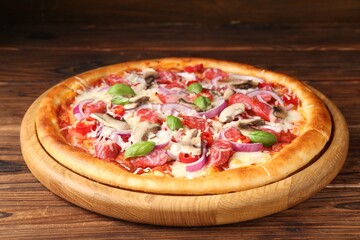 Tasty pizza with smoked sausages and mushrooms on wooden table, closeup