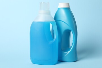 Bottles of fabric softener on light blue background