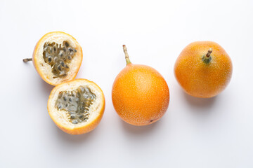Ripe passion fruits on white background, flat lay