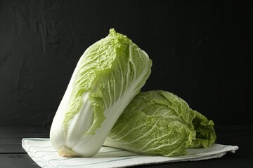 Fresh Chinese cabbages on black wooden table